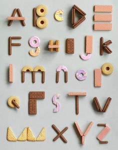 the letters and numbers are made out of different types of doughnuts, cookies, and candy