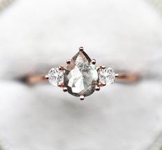 an engagement ring with three diamonds on it