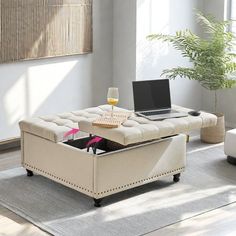 a living room filled with furniture and a laptop computer on top of a coffee table