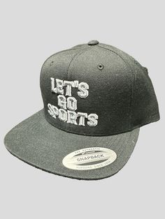 Let's Go Sports snapback cap. The perfect hat to wear when going to a game and repping any sport! This is a staple in any outfit, to add style whether dressed up or down. This cap allows effortless style and comfort. You'll definitely get compliments with this one! Sporty Outdoor Fitted Hat With Flat Brim, Sports Flat Cap For Baseball Season, Urban Baseball Cap For Sports Events, Urban Style Baseball Cap For Sports Events, Urban Hat For Baseball Season, Sporty Flat Cap Fitted Hat For Sports, Urban Style Hat For Baseball Season, Urban Style Sports Hats For Baseball Season, Sporty Snapback Fitted Hat For Outdoor Activities