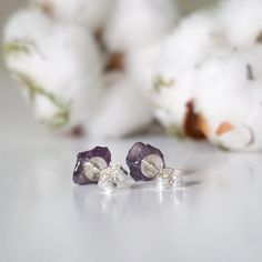 Open your self to wisdom and higher level protection when wearing these raw amethyst earrings. Known as the stone of higher knowledge, amethyst's energies reduce stress and give you insight into the world. With this option, we send you an image of four amethyst pairs to vibe with and let us know what stones you want as your- or your awesome person's- earrings. Earrings made of raw natural amethyst Dimensions range from ⅓”-½” tall by ⅓”-½” wide (8.3 - 12.7mm tall by 8.3 - 12.7mm wide) Each pair u Lavender Earrings With Natural Stones For Gift, Nickel-free Amethyst Earrings For Healing, Lavender Gemstone Earrings For Gifts, Amethyst Birthstone Earrings As A Gift, Amethyst Birthstone Earrings For Gift, Spiritual Amethyst Earrings With Natural Stones, Healing Amethyst Earrings With Natural Stones, Amethyst Natural Stone Earrings As Gift, Amethyst Earrings With Natural Stones For Gift