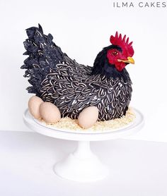 a cake shaped like a chicken sitting on top of a white plate