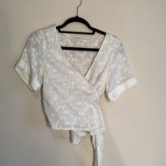 Gorgeous White Linen Top. Can Be Tied Several Different Ways With Very Long Ties As Shown In Picture. Looks Gorgeous On, Super Flattering. Sheer Material, So Need To Wear Cami Bralette Under! Cuff Sleeved Detail As Well! Size Shown Is A Eu 38 Which Translates To A 10 Or 12 American. Fits Like A L/Xl. New Without Tags, Never Worn! Spring Vacation Tops With Tie Waist, Chic White Wrap Top, Summer Top With Tie Waist For Brunch, Summer Tie Waist Blouse For Day Out, Spring Beach Tops With Tie Waist, Short Sleeve Wrap Top For Day Out, Chic Cotton Wrap Top For Summer, Spring Chic Crop Top With Tie Waist, Chic Spring Crop Top With Tie Waist