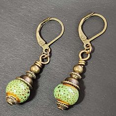 "If you love vintage things, and rustic/retro style, you will love adding these earrings to your collection. Hand crafted with handmade ceramic clay beads in speckled green round beads. Accent beads are metal. These earrings are so cute! Ceramic beads are about 9mm These earrings are about 1.5 inches long including the ear wires.  The metal is antiqued bronze colored. The earwires are alloy (nickel-free, lead-free, cadmium-free) which is good for most people with sensitive ears. Ear wires are le Adjustable Retro Drop Earrings, Retro Adjustable Drop Earrings, Adjustable Nickel-free Retro Earrings, Handmade Retro Jewelry For Everyday Wear, Handmade Retro Everyday Jewelry, Nickel-free Vintage Drop Beaded Earrings, Vintage Nickel-free Drop Beaded Earrings, Retro Earrings With Vintage Charm For Gift, Handmade Retro Dangle Jewelry