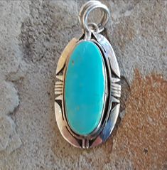 Turquoise Engraved Amulet Jewelry, Amulet Style Turquoise Necklace With Large Pendant, Turquoise Amulet Necklace With Large Pendant, Engraved Turquoise Amulet Jewelry, Artisan Blue Turquoise Teardrop Pendant Necklace, Turquoise Jewelry With Large Oval Pendant, Handmade Turquoise Medallion Necklace, Turquoise Round Pendant Amulet Necklace, Artisan Blue Teardrop Pendant Jewelry