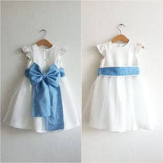 two pictures of dresses with blue bows on the front and back, one in white