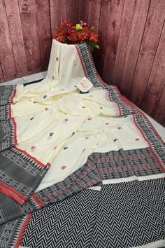 This cotton handloom saree features a tasteful combination of off-white and black colors, complemented by intricate red and black buti work on the whole body. Crafted with quality cotton, this saree offers both softness and comfort. Elegantly designed for a timeless look. Color: A shade of offwhite and black color Technique: Amazing and traditional work of hand weaving done all over by artisans Fabric: Cotton Color Techniques, Whole Body, Handloom Saree, Blouse Piece, Saree Blouse, Red And Black, Fabric Cotton, Work On, Black Color