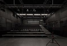 an empty auditorium with rows of seats and lights