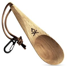 a wooden spoon with an x on it and a pair of scissors hanging from the handle