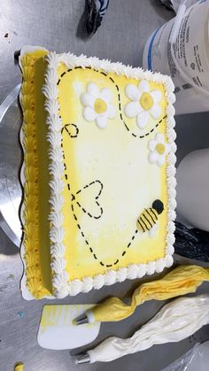 there is a cake that has been decorated with yellow and white icing on it