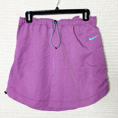 Nike Sportswear Swoosh Woven Skirt. Dusty Purple With Bright Blue Ascents. Drawcord Waist And Sides. High Waisted, High Rise. Measurements: 15” Waist, 16.5” - 17.5” Length Material: 100% Nylon Condition: Brand New With Tags. No Flaws. Athleisure, Loungewear, Athletic, Yoga, Workout, Running, Spring, Summer, Vacation, Beach, Cruise, Casual. Purple Stretch Skort For Sports, Pink Casual Workout Skirt, Casual Pink Workout Skirt, Casual Workout Skirt For Spring, Casual Spring Workout Skirt, Sporty Stretch Purple Skort, Casual Sports Skirt With Go-dry Technology, Casual Go-dry Sports Skirt, Sporty Skirt For Spring Sports