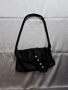 "This day or evening black satin 1950's retro style bag has pearlescent button accents and is very lightweight w/ a magnetic snap closure.  It measures approx 6\" by 10\" and has a shoulder strap made of black twisted rope that hangs approx 9\".  The lining is silver satin." Black Formal Evening Bag With Pearl Handle, Formal Black Shoulder Bag With Pearl Handle, Formal Black Evening Bag With Pearl Handle, Elegant Party Shoulder Bag With Snap Closure, Vintage Evening Shoulder Bag With Pearl Handle, Satin Noir, Retro Stil, Clutch Handbag, Black Satin