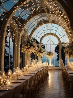 an indoor wedding venue set up with white flowers and candles