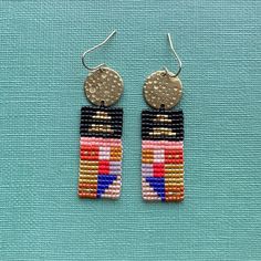 Quilt and textile inspired bars of color, made with glass Miyuki Delica beads, brass toppers, and a 14 K gold plated hypoallergenic ear wire Multicolor Beaded Brass Earrings, Artisan Multicolor Beaded Earrings With Gold Beads, Gold Brass Earrings With Colorful Beads, Gold Rectangular Jewelry For Summer, Rectangular Gold Jewelry For Summer, Rectangular Gold Summer Jewelry, Beaded Brass Earrings For Festival, Multicolor Dangling Beaded Brass Earrings, Multicolor Brass Beaded Earrings For Festival