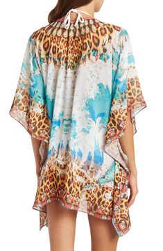 Unleash your boho spirit in this lace-up cover-up kimono styled with vivid allover patterns. 33'' length (O/S) Lace-up closure V-neck Kimono sleeves 100% polyester Dry clean Imported Model stats: 5'10", 32" bust, 25" waist, 36" hip. Model is wearing size OS. Festival Boho Print Beachwear Cover-up, Boho Print Cover-up With Kimono Sleeves For Beach Season, Bohemian Multicolor Printed Cover-up, Bohemian Multicolor Tunic Cover-up, Multicolor Beachwear Cover-up For Festival, Multicolor Print Kaftan For Beach Cover-up, Bohemian V-neck Cover-up With Tropical Print, Multicolor Festival Beachwear Cover-up, Bohemian V-neck Tropical Print Cover-up