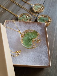 a box with four pieces of jewelry in it on a table next to other items