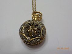 "Vintage 1928 brand pocket watch style locket pendant. 28\" chain with barrel fastener. Gold tone pocket watch style locket, including bale is 1 1/4\" x 3/4\". Hinged locket holds two photos. Gorgeous filigree design on the front of the locket & gold tone trim around the outer edge on the backside. This is in excellent vintage condition. Pre-owned & gorgeous! Signed with 1928 hang tag." Ornate Formal Locket Necklace, Formal Ornate Round Locket Necklace, Antique Gold Filigree Locket Necklace For Formal Occasions, Vintage Coin Necklace For Formal Occasions, Vintage Coin Necklaces For Formal Occasions, Formal Antique Gold Medallion Locket Necklace, Ornate Round Pendant Locket Necklace For Formal Occasions, Formal Antique Gold Brass Locket Necklace, Vintage Hallmarked Round Pocket Watch