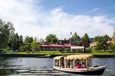 a boat with people on it traveling down the river