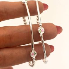 This charming jewelry sterling silver set features pink tulip charms, making it the perfect gift for bridesmaids or as a thoughtful graduation gift. You can gift this set as 16th birthday girl or a quinceañera girl as perfect and delicate jewelry gift . KEY FEATURES :   * Sterling silver Tulip charm /enamel (round 6mm)  * Highest-quality Sterling Silver heart charms (7mm)  * 3mm and 4mm Sterling silver Beads  * Sterling silver Tubes (30 and 40mm)   * Durable 1mm stretchy cord   * All  items feat Delicate Wedding Jewelry With Charms, Sterling Silver Jewelry With Pink Flower Charm, Dainty Dangle Jewelry For Mother's Day, Feminine Sterling Silver Dangle Jewelry, Adjustable Jewelry For Bridesmaid Gift, White Gold Sterling Silver Jewelry For Bridesmaids, Dainty Silver Charm Bracelet For Bridesmaid Gift, Silver Birth Flower Bracelets As A Gift, Silver Birth Flower Bracelets For Gifts