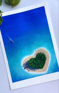 an island shaped like a heart with a boat in the water