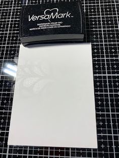 a white sheet of paper sitting on top of a black and white tiled countertop