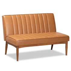 a tan leather couch with wooden legs