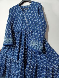 A Indian block print indian cotton dress Cotton, Pure Cotton, Block Print, Hand Made, Hand Block, Wooden Dye, Vegetable Dye, Natural Dye, Long Dress, Easy Wear, Blue Dress, Christmas, Natural Colour Description Hand block printing is an ancient art form that utilizes a hand carved wood block, dipped in dye and stamped by hand onto fabric. Size - bust 40-42 inch Waist-38-40 inch Hips_52 inch Length --50 inch Round-80-100 inch whole Hand wash cold separately. 100% cotton fabric. The model is weari Traditional Cotton V-neck Kurta, Cotton Tunic Dress For Navratri, Traditional Cotton V-neck Dress, Cotton V-neck Kurta For Navratri, Festive Bohemian Cotton Dress, Cotton Dresses With Printed Motifs For Festivals, Long Sleeve Mulmul Dress With Printed Motifs, Traditional Cotton Dress With Boho Print, Festive Cotton Ikat Print Dress