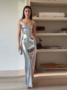 Expertly designed for a stunning and sophisticated look, the Socialite Silver Sequin Cut Out Sleeveless Maxi Dress is a must-have for any glamorous occasion. The intricate sequin detailing adds a touch of sparkle, while the cut-out sleeves and maxi length create an effortlessly chic silhouette. Elevate your style with this elegant dress. 100% Polyester Dry Clean Zipper Closure Due To High Demand-Please Allow 2-3 Weeks For Delivery Brand Size Dress Bust Waist Hip XS 0-2 31-32.5'' 23-24'' 31-34" S Sleeveless Dress With Contrast Sequin For Evening, Sequin Dress For Gala Evening, Sleeveless Sequined Evening Dress, Chic Sleeveless Evening Sequin Dress, Sleeveless Sequin Fabric For Prom Season Party, Elegant Floor-length Sequin Fabric For Party, Sleeveless Evening Dress With Contrast Sequin, Sparkling Sleeveless Cocktail Dress, Contrast Sequin Sleeveless Evening Dress