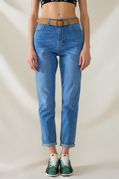 Introducing the High Waist Mom Jeans in Mid Wash Stretch Denim, a stylish and versatile addition to your wardrobe. These mom fit jeans feature a beautiful mid-wash and are crafted from a blend of 62% cotton, 36% polyester, and 2% elastane, ensuring both comfort and durability.  With a regular waist rise and a regular fit, these jeans offer a timeless silhouette that flatters various body shapes. They include classic details such as a button and zipper closure, along with five functional pockets and belt loops for added convenience. The model is wearing size S, with measurements of 33-24-36 and a height of 5'11".  The XS-S-M-L-XL sizing corresponds to US sizes 2, 4, 6, 8, and 10 respectively. These ankle-length jeans are perfect for daily wear, pairing effortlessly with crop tops or blouses Mom Fit Jeans, High Waist Mom Jeans, Types Of Jeans, Ankle Length Jeans, Skirt Jumpsuit, Romper Pants, Sweater Coats, Jean Shirts, Comfortable Outfits