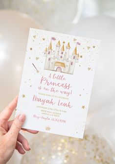 a hand holding up a princess birthday card with gold foil stars and castle on it