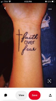 a woman's wrist tattoo with the words faith over fear