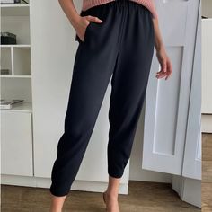 These Are Slim-Fit Tuxedo Pants With An Easy, Pull-On Waistband And An Ankle-Grazing Length. They're Precisely Tailored With Terado, A Japanese Fabric That's Matte Crepe On One Side And Satin On The Other Half-Elasticated Hem For A Slim Leg Inseam Pockets Pull-On Waistband With Elastic Back Twisted Leg Seams For A Streamlined Silhouette Materials & Care Origin: Fabric From Japan Content: 82% Triacetate, 18% Polyester Care: Dry Clean Imported Aritzia Babaton Xs Black Dress Pants. Nwt Inseam 24. E Black Dress Pants With Pockets For Spring, Black Dress Pants Loosely Fitted For Spring, Black Dress Pants With Loosely Fitted Hips For Spring, Black Ankle-length Pants For Business Casual, Black Dress Pants With Elastic Waistband For Spring, Black Loose Fit Ankle-length Dress Pants, Elegant Tapered Leg Pants For Loungewear, Black Non-stretch Pants For Work, Black Pants With Elastic Waistband For Business Casual