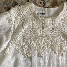 Super fun 1980s blouse with extravagant collar and embroidered lace. Love this Victorian prairie style! Perfect with a pair of high waisted jeans. The shirt has been made from a soft polyester jacquard. Giant crochet embroidered lace collar. Pleated bodice. Gathered puff sleeves. Peplum waist band. Fully lined. Two buttons at the back neck. Label In the Mood, London, Paris, size 10. Please hand wash cool, drip dry. Very good vintage condition with no sewing or fabric flaws. Measurements Shoulder Fitted Lace Top With Puff Sleeves And Lace Collar, Embroidered Fitted Lace Top For Wedding, Fitted Tops For Baptism In Spring, Fitted Top For Baptism In Spring, Giant Crochet, Linen Sheath Dress, Prairie Style, Pleated Bodice, Neck Label