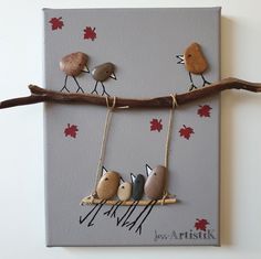 three little birds on a branch hanging from a string with autumn leaves painted on it