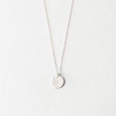 Our small 9mm disk pendant, offered with a smooth or hammered finish. Everyday Hammered Round Disc Coin Necklace, Everyday Minimalist Hammered Coin Necklace, Everyday Hammered Coin Necklace With Round Pendant, Minimalist Hammered Coin Necklace, Silver Hammered Round Disc Necklace, Minimalist Hammered Round Coin Necklace, Minimalist Round Hammered Coin Necklace, Hammered Round Coin Necklace, Hammered Medallion Coin Necklace In Sterling Silver