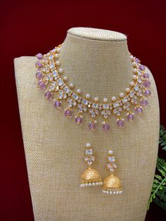 This elegant Robin tyanni kundan choker/necklace is gold-plated with tyanni kundan work and a pearl neckline. The piece is finished with lavender/lilac crystal drops and matching jhumki, all embellished with traditional kundan work. Its length is about 2 inches, with a secure push-back closure. Kundan Choker Necklace, Kundan Work, Kundan Choker, Crystal Drop, Choker, Choker Necklace, Lilac, Gold Plate, Lavender