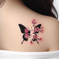 a woman with a butterfly tattoo on her upper back shoulder and breast is looking at the camera