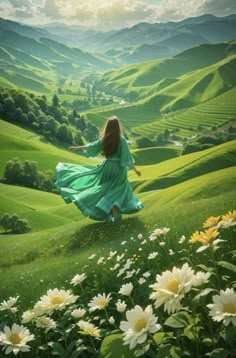 a woman in a green dress is walking through the grass with daisies and mountains behind her