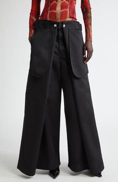 The maison's penchant for unconventional silhouettes is emphasized in the layered design of wide-leg pants that create a four-leg wrapped illusion. 30" inseam; 28" leg opening; 15 1/2" front rise; 17 1/2" back rise (size Medium) Zip fly with hook-and-bar closure Front welt pockets 65% polyester, 35% cotton Machine wash, dry flat Made in Portugal Designer Clothing Avant-garde Black Wide Leg Pants, Ballroom Culture, Wide Leg Pants Pattern, Jean Paul Gaultier Women, Lace Up Trousers, Designer Clothing Brands, Wrap Pants, Summer Wardrobe Essentials, Flare Leg Pants