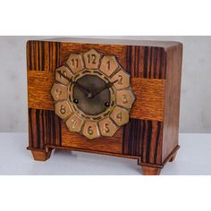 a small wooden clock with numbers on it