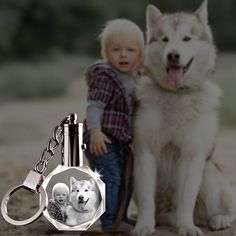 a key chain with an image of a dog and a child on it is shown