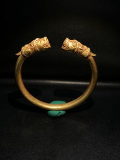 A Beautiful Old Bracelet Of Gold At The Two Ends Decorated With Tiger Head Figure Symbolize Might Strength. Worn For Protection and prosperity Good patina on the surface and certification of gold available On Request Of Customer Great quality and excellent collection Gold Collectible Bracelet, Gold Brass Bangle For Collectible, Unique Gold Collectible Bracelets, Unique Yellow Gold Brass Bracelet, Traditional Carved Yellow Gold Jewelry, Bronze Bracelet For Ceremonial Occasions, Gold Ceremonial Bracelet, Temple Jewelry Brass Bangle Bracelet, Traditional Yellow Gold Carved Jewelry