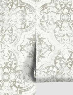 the back side of a wallpaper with an intricate design on it, in grey and white