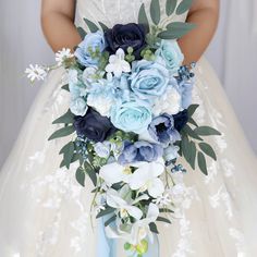 a bridal holding a bouquet of blue and white flowers