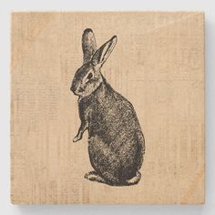 a wooden block with a drawing of a rabbit on it's back and ears