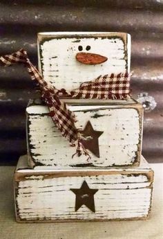 three wooden boxes decorated with snowmen and stars are stacked on top of each other