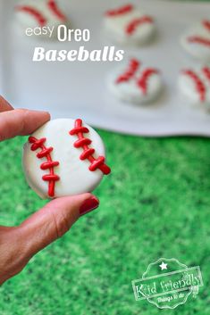 a person holding a baseball shaped cookie in their hand