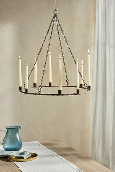 a chandelier with candles hanging from it