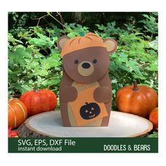 a paper cut out of a bear holding a pumpkin