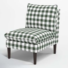 a green and white checkered chair sitting on top of a wooden legrests